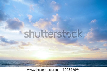 seascape and sun on blue sky background Royalty-Free Stock Photo #1102399694
