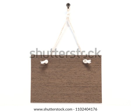 Wooden sign with natural pattern with rope hanging on white space with empty space.