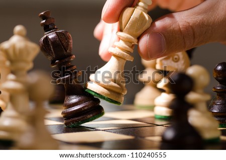 playing wooden chess pieces Royalty-Free Stock Photo #110240555