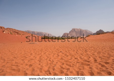 Red sand dunes and sandstone cliffs in Wadi Rum desert, Jordan