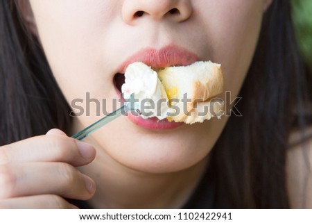woman eating creamy toast.