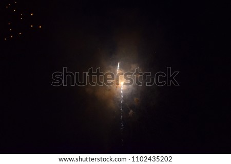 Flare light on the sky with grey cloud and black sky. Firework, beauty light on the sky in night for festive, celebrate, party, etc.