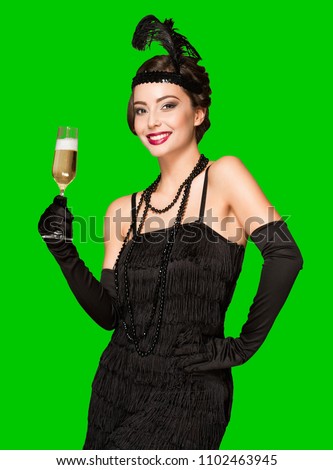 Portrait of 20s style festive beauty with glass of champagne. Royalty-Free Stock Photo #1102463945