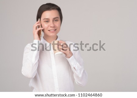 Young business girl talks on the phone isolated