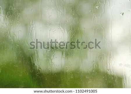 the rain outside the window. rain drops on glass spring or autumn