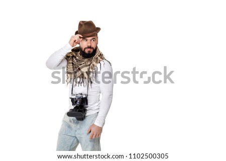 stylish young male photographer with retro camera takes photos on white background