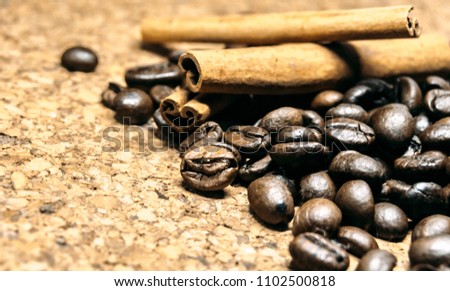 Fresh black coffe beans on cork table
