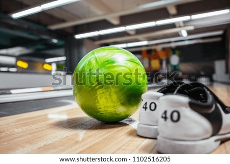 Pair of bowling shoes and ball with blurred line background