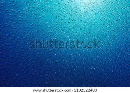 Water drops on Blue Background. Photo Image