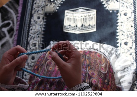 A young woman prays on the floor, during the month of Ramadan