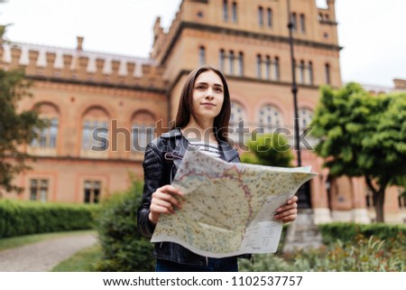 Attractive young female tourist is exploring new city.