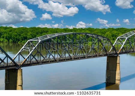 Truss bridge over the Mississippi River. Royalty-Free Stock Photo #1102635731