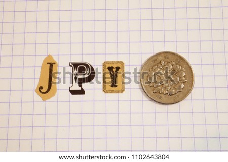JPY (Japanese Yen) Text at Notebook, with Coin