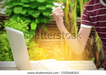 Happy excited young girl at home with raised hands,Enjoying time, Hand of  young  girl working on laptop , celebrating the success business, Game mission completed and Success