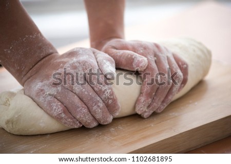 Baker hand kneading dough