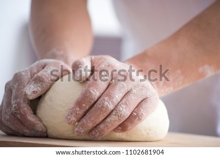 Baker hand kneading dough