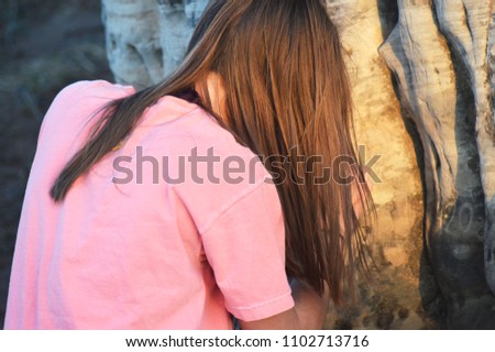 Girl Carving into a Rock