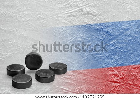 Hockey pucks and the image of the Russian flag on the ice. Concept, hockey, background