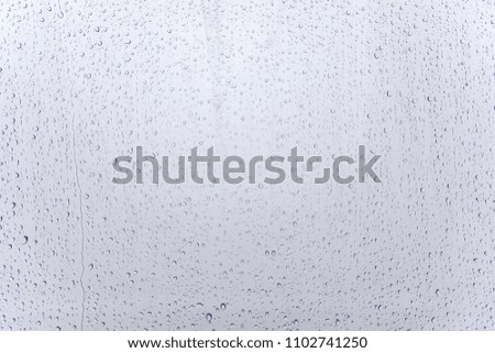 Wet glass background. Rain on the glass. Water drops