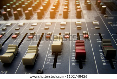 Volume control of the soundboard in the control room and voice recorder. Royalty-Free Stock Photo #1102748426