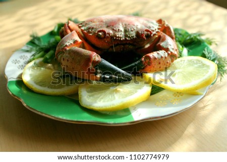 BOILED CRAB ON A PLATE WITH LEMON
