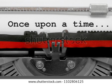 Once upon a time ... phrase written by an old typewriter on white sheet Royalty-Free Stock Photo #1102806125