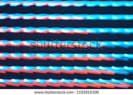 LED lights on the billboard. This is blurred photography, taken by slow shutter speeds and moving the camera in different directions while pressing the shutter button. This is not the illustration.  