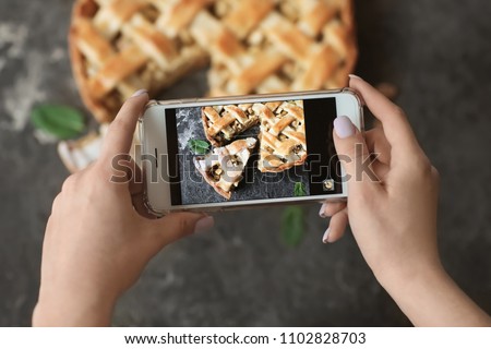 Woman taking photo of tasty homemade apple pie, closeup