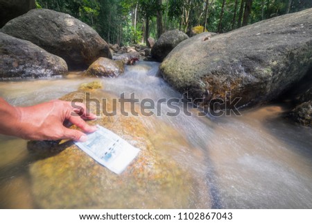Money and continuous water flowing in the river . Money Concept
