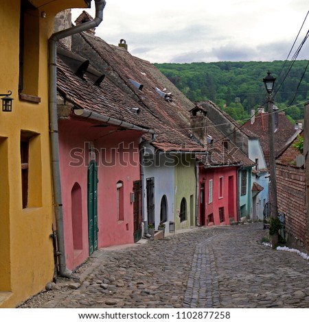Medieval Alley In Sighisoara stock images. Sighisoara Romania. Colored street in Romania. Sighisoara old town. Old houses in Romania. Ancient architecture in Transylvania