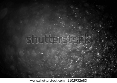 Texture of white liquid drops on a black background for a filter.
