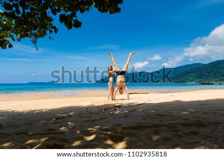 Landscape with young tourist couple on tropical Tioman island in Malaysia. Beautiful seascape of south east asia on Tekek beach.