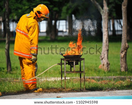 Firefighter showing fire extinguishers
