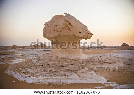Desert landscape in Egypt. White desert in Egypt (Farafra). White stones and yellow sands. Sahara desert at sunset.