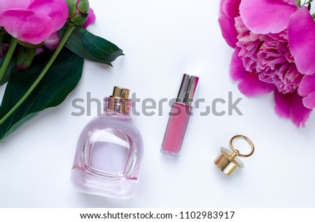 Pink peony flower bottle of perfume and lipstick pink woman mood Flat lay Nature concept on white background with copy space. Mother's Day and spring background concept.