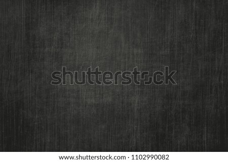 Brushed scratched dark metal texture. Polished metal texture background with light reflection.