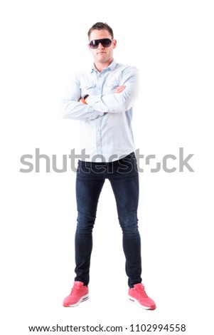 Successful confident proud stylish business man wearing sunglasses with crossed hands. Full body isolated on white background.