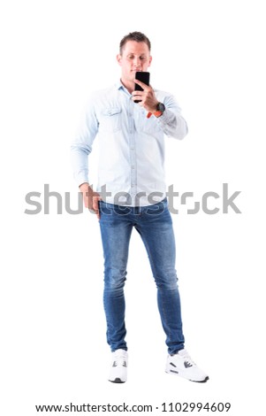 Relaxed content elegant business man taking photo with smart phone. Full body isolated on white background.