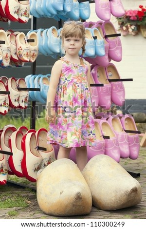 Lovely girl posing in typical dutch huge wooden clogs