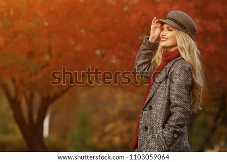 Young woman smiling on the red garden background, copy space