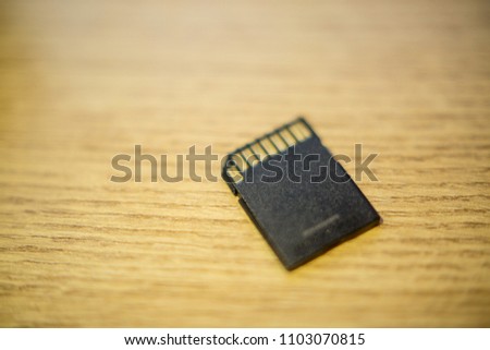 SD card on an old wooden table, close-up