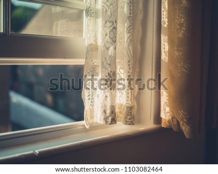 Afternoon sunlight hitting a curtain through the window