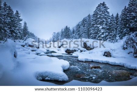 River covered in snow winter landscape. Royalty-Free Stock Photo #1103096423