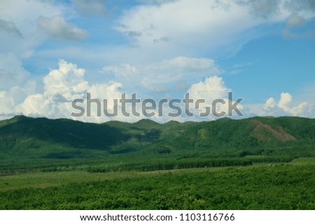 Clouds in the blue sky and mountains