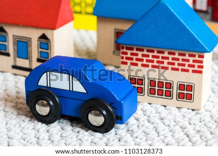 Close up of a toddlers wooden car and town set, useful for cencepts