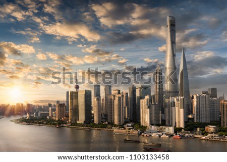 View to the modern skyline of Shanghai, China, on the Huangpu river during sunset time