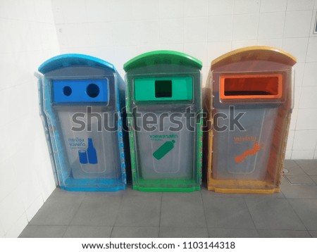 Three type and colour symbol of bin on floor that show in Thai language ; for Cans and Glasses, PET bottles, Others 