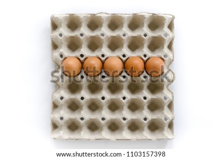 Number letters arrange from eggs in paper tray on white background.