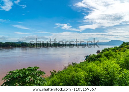 The Mekong River that flows between Laos and Thailand on panorama view with blue sky.