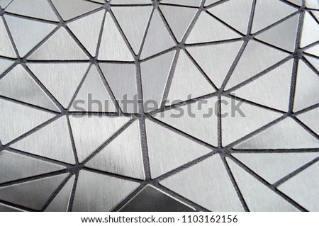 Beautiful texture of gray carved patterned plastic triangles with rounded corners and lines. The background.
